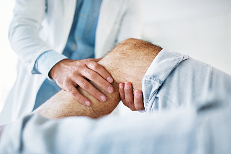 Call Doctor UAE Physiotherapist helping patient with knee osteoarthritis