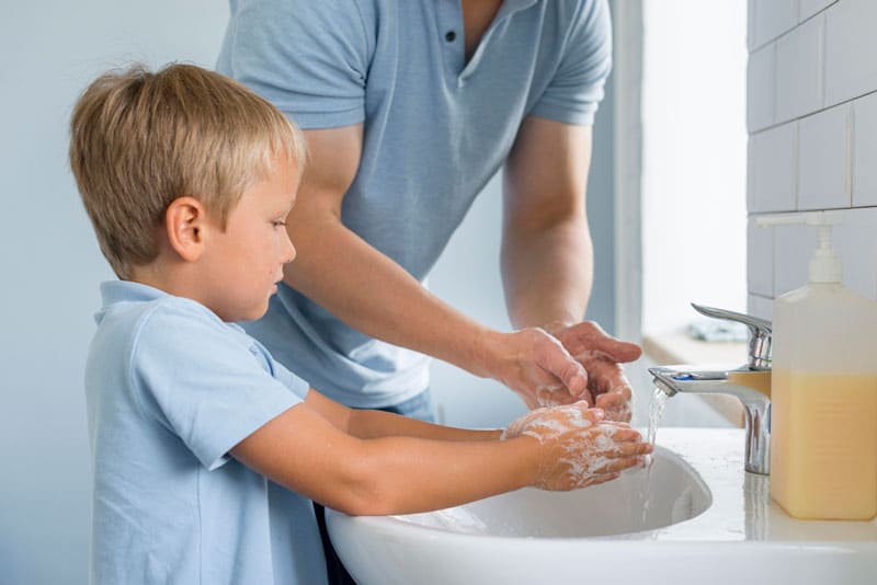 close-up-father-teaching-son-how-wash-hands
